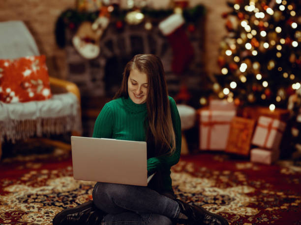 istock Woman using laptop computer on Christmas Eve at home 2188546550