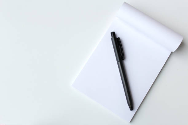 istock Black pen and white paper notepad banner background with copy space. 2188547215