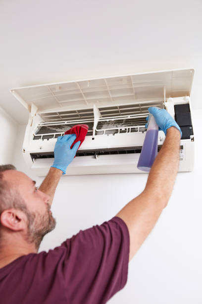 istock Man cleaning and maintaining air condition unit at home. 2188548345