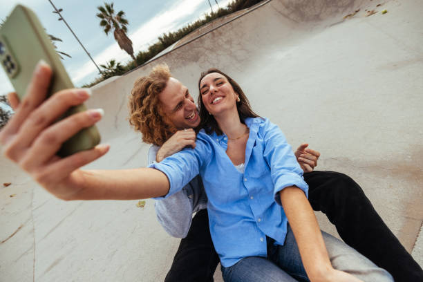 istock Young couple taking a selfie in a skate park 2188551384