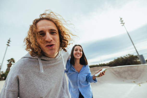 istock Young skaters having fun with smartphone at the skatepark 2188551397