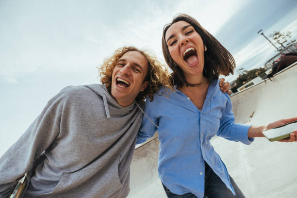 istock Young skaters laughing out loud at the skate park 2188551403