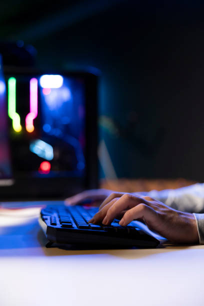 istock Man using keyboard to move character in game, playing with teammates, close up 2188551824