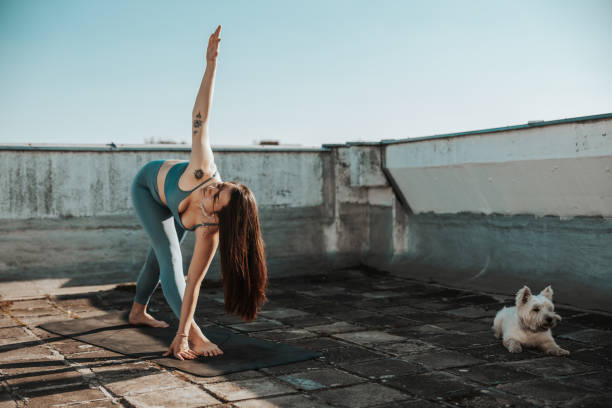 istock Woman Doing Yoga Outdoors On A Rooftop Terrace 2188552017