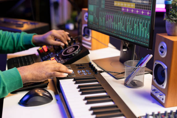 istock Music producer twisting pre amp knobs on mixing console 2188555179