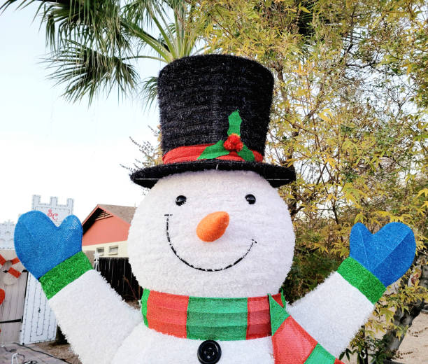 Phoenix, AZ - November 17, 2024:  Merry Christmas welcome from a traditional outdoor snowman set up at roadside in mid-November