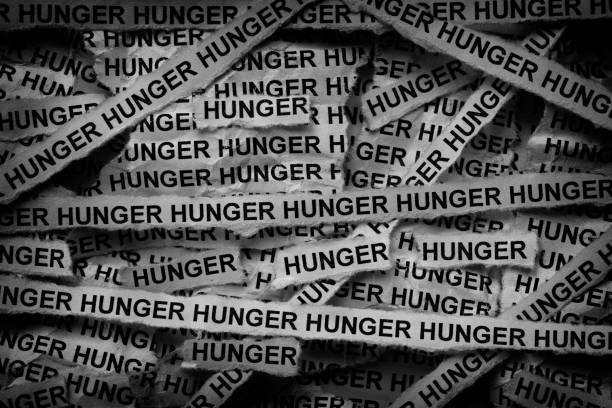 istock Strips of newspaper with the words Hunger typed on them. 2188561207