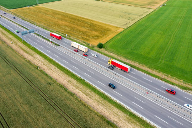 istock Trucks and cars on a highway 2188563541