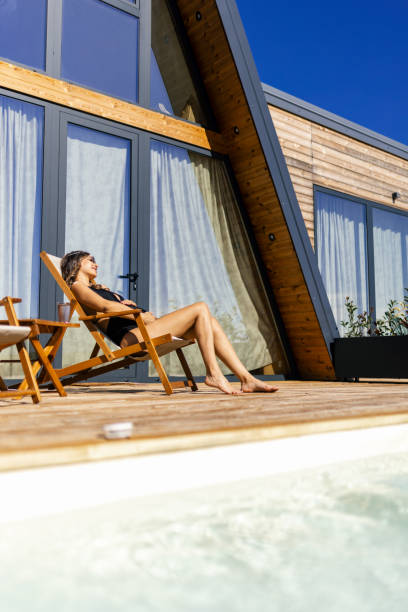 istock Pregnant woman sunbathing on patio next to hot tub 2188564365