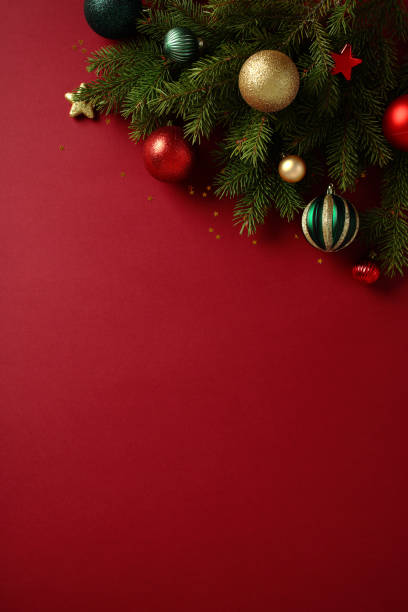 istock Vertical Christmas background with pine branches and ornaments on red. New nostalgia style. Perfect for holiday designs 2188567695