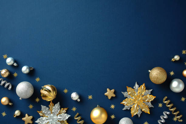 istock Christmas flat lay composition with gold and silver festive ornaments on a dark blue background, ideal for seasonal designs. Chic, luxury style. 2188567996