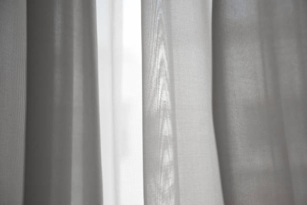 istock White silk curtains in the house near window 2188569072