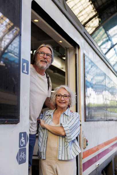 istock Senior couple boarding a train for travel 2188571395