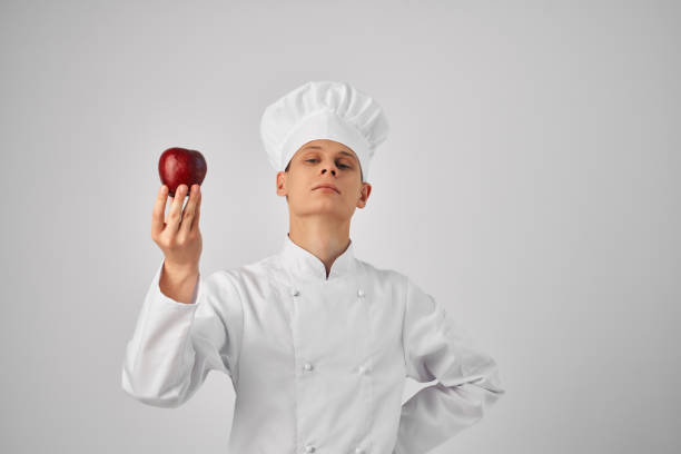chef with an apple in his hands groceries work professional cooking. High quality photo