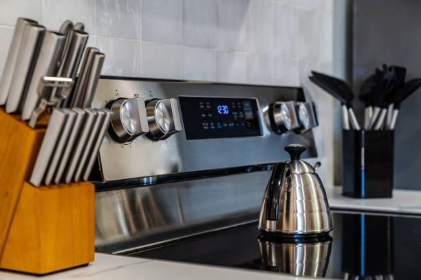 Stainless Steel Stovetop with Kettle and Kitchen Utensils