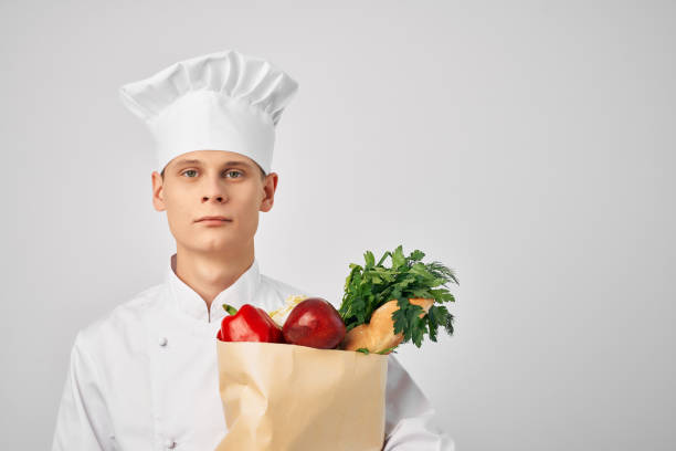 istock man in chef's uniform package with groceries cooking restaurant work 2188576692