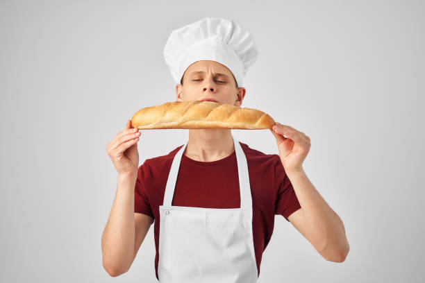 istock Baker in a white apron loaf in the hands of cooking 2188577408