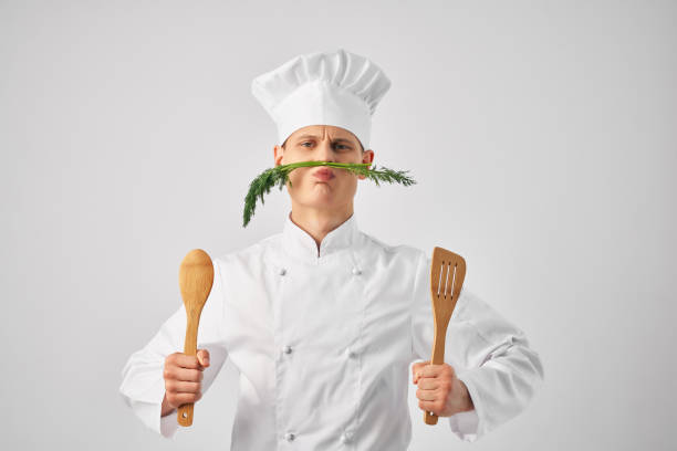 istock chef with kitchen utensils greens near face restaurant 2188577754