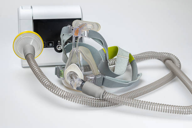 istock Continuous positive airway pressure system includes of CPAP machine, mask, tube on white background. 2188580580
