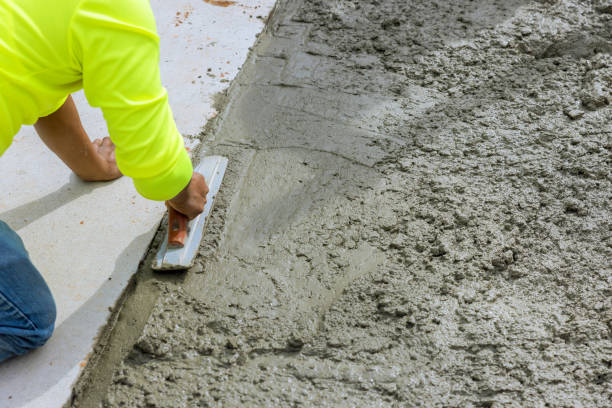 istock Worker smoothing concrete surface ta construction site during daylight in a residential area 2188581847