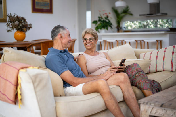 istock Carefree senior couple using personal device and laughing 2188582094