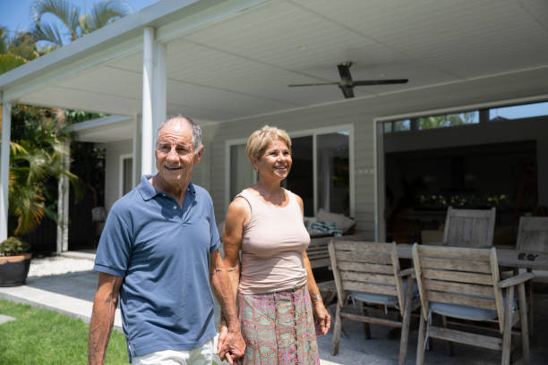 istock Retired couple walking in back yard sunshine 2188582142