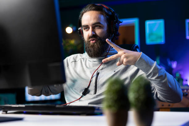 istock Delighted player brags after being victorious in videogame, doing hand gesture 2188582880