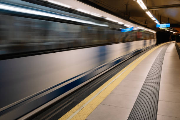 istock A blurry image of a train on a subway platform with a child walking on the platform. 2188583580