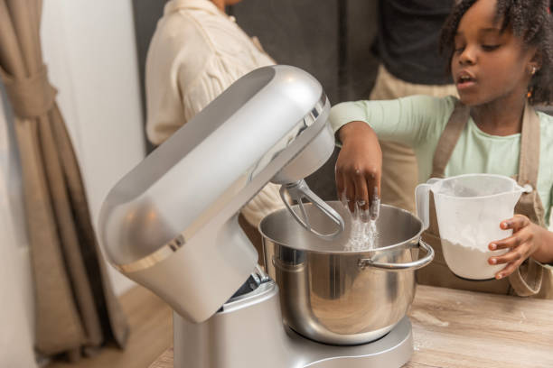 Beautiful young black girl preparing a xmas cake alone