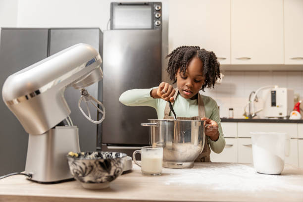 istock Beautiful young black girl preparing a xmas cake alone 2188584651