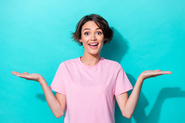 istock Photo of young attractive gorgeous nice lady hold two hands palms demonstrating objects smiling isolated on aquamarine color background 2188595654