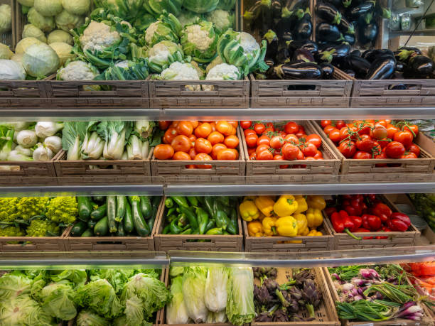 istock Vegetables displayed in boxes on shelves in the greengrocer's shop 2188596490
