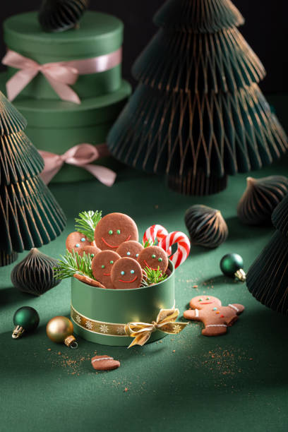 istock Sweet Christmas gingerbread mans in dark green gift box. 2188604958