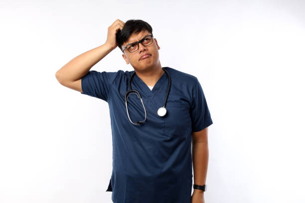 istock Hispanic man feeling puzzled and confused, scratching head. nurse concept 2188605077
