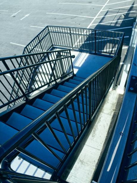 Staircase leading down to parking area. Steps design element with sharp angles.