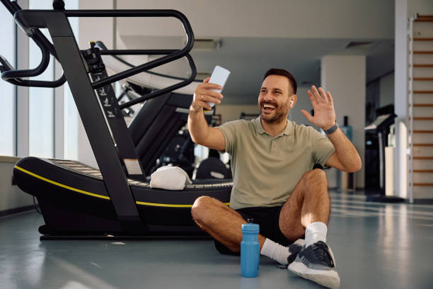 istock Happy athlete making video call during sports training in a gym. 2188605966