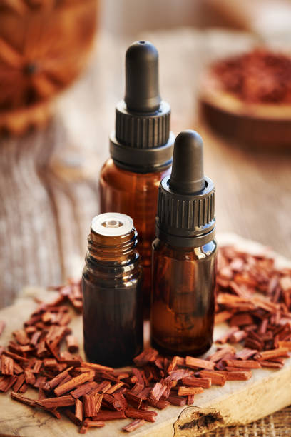 istock Three bottles of aromatherapy essential ol with red sandalwood 2188606923