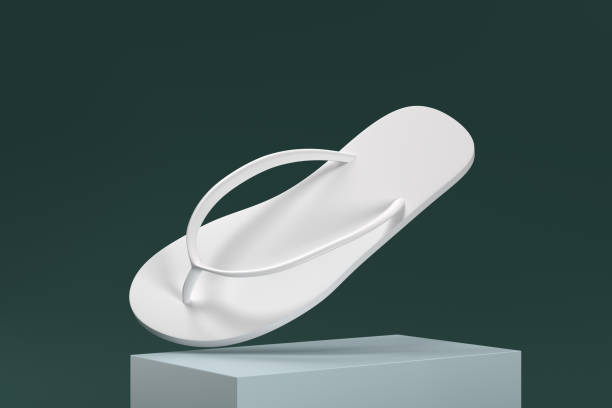 A white flip flop is shown in a 3D image. The flip flop is placed on a white block, and the image is set against a green background