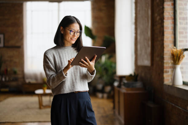 istock Businesswoman Using Tablet In Modern Office With Natural Light 2188611217