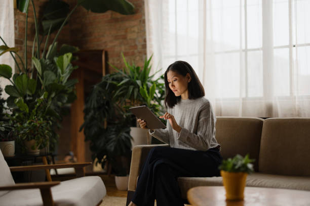 istock Woman Working Remotely on Tablet in Modern Urban Office Lounge 2188611254