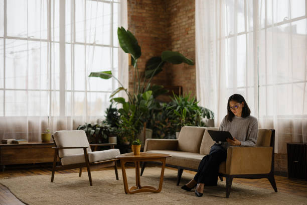 istock Professional Woman Working on Tablet in Modern Office Lounge Area 2188611265