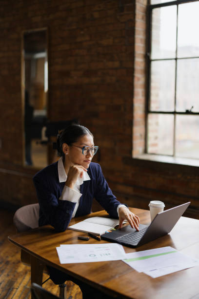 istock Businesswoman Working Alone In a Modern Loft Office Setting 2188611278