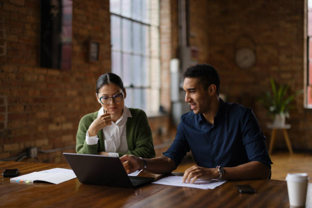 istock Two Colleagues Collaborating in a Modern Office Environment with Technology 2188611315