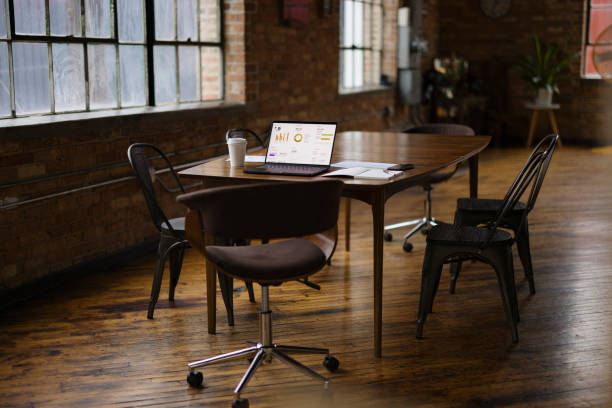 istock Modern Industrial Office Space With Laptop and Coffee on Table 2188611316