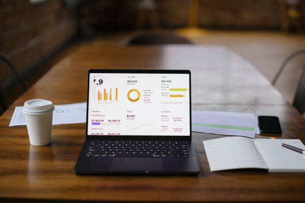 istock Modern Office Desk With Laptop Displaying Business Analytics 2188611322