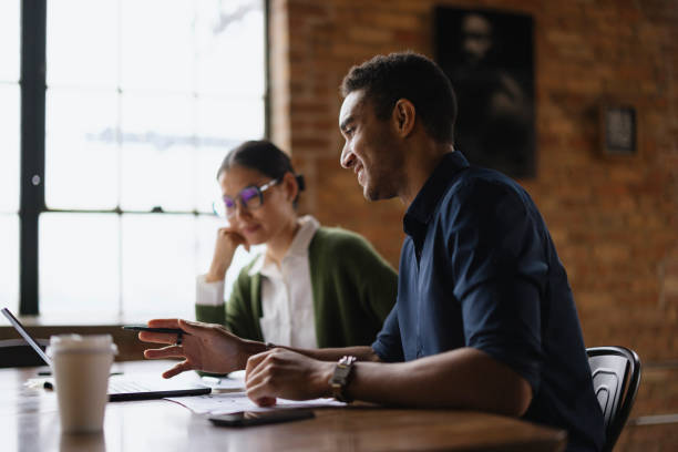 istock Young Professionals Engaged in a Modern Office Setting Meeting 2188611325