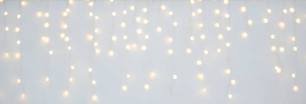 istock Christmas light decoration blurred festive gold bokeh light on white background 2188614596