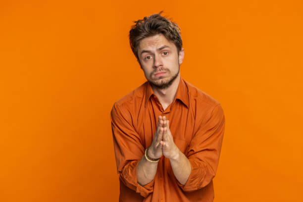 istock Caucasian sad man praying making wish, asking hopeful help, begging apology, meditation, imploring 2188615079