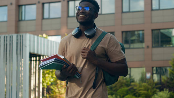 istock African American happy smiling student guy ethnic university man male with backpack school bag and books smile walking in city outdoors in academy college university campus on education class lesson 2188616516