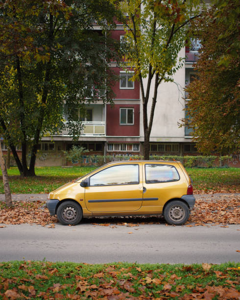 Side view of cute yellow Renault Twingo Mk1, parked in Subotica, Serbia, 30.10.24. Its small size and rounded shape, showcasing its distinct personality as a 1990s icon of urban mobility.